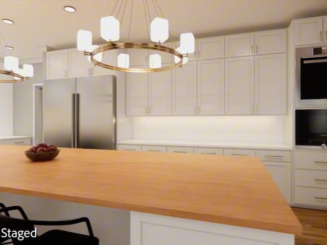 12 Columbia Ct, Lufkin, TX 75901 - kitchen with appliances with stainless steel finishes, a chandelier, butcher block countertops, white cabinets, and recessed lighting