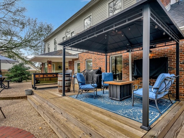 wooden terrace featuring area for grilling