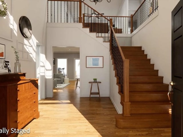 12 Columbia Ct, Lufkin, TX 75901 - foyer entrance featuring stairs, a high ceiling, wood finished floors, and baseboards