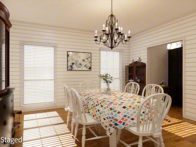 12 Columbia Ct, Lufkin, TX 75901 - dining space featuring a chandelier, light wood-type flooring, and wood walls
