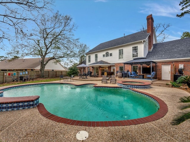 view of swimming pool with a gazebo, an in ground hot tub, and a patio