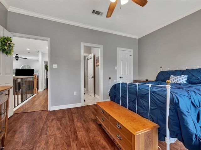 bedroom with wood-type flooring, connected bathroom, ceiling fan, and crown molding