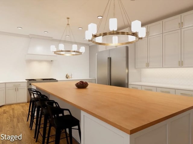 12 Columbia Ct, Lufkin, TX 75901 - kitchen featuring high end fridge, a chandelier, a kitchen island, light wood-style floors, and recessed lighting