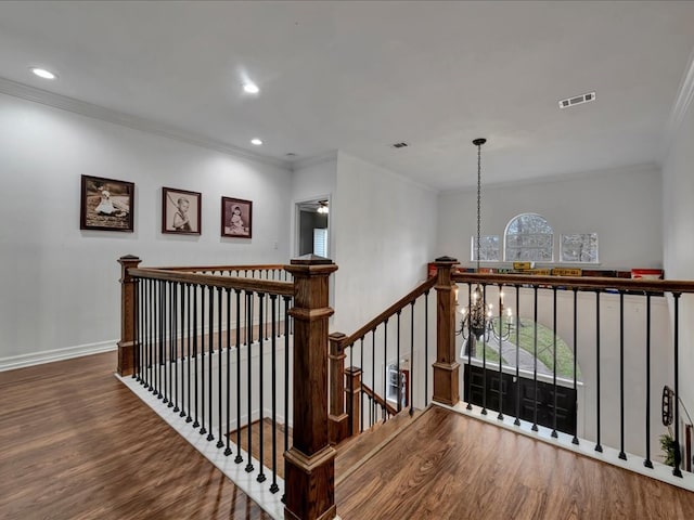 stairs featuring crown molding, hardwood / wood-style floors, and ceiling fan