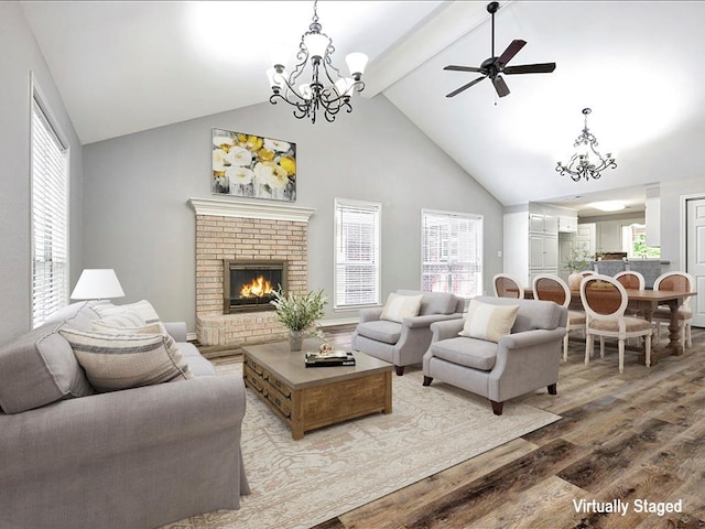 living room featuring plenty of natural light, beam ceiling, and wood finished floors