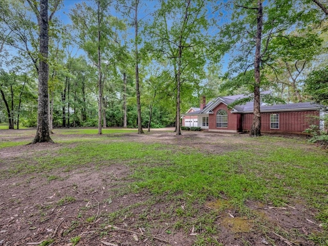 view of yard with driveway and a garage