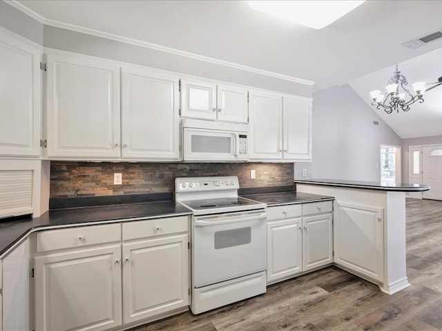 kitchen with dark countertops, white appliances, and white cabinetry