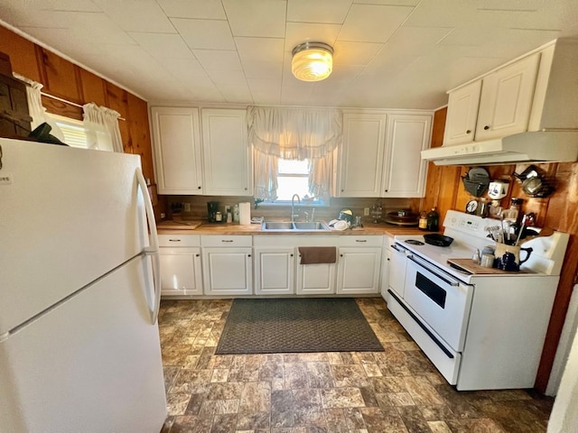 kitchen with white appliances, white cabinetry, and sink