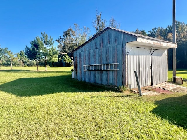 view of outdoor structure featuring a lawn