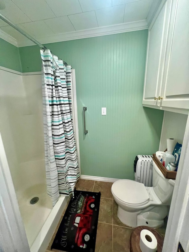 bathroom with crown molding, tile patterned flooring, and walk in shower