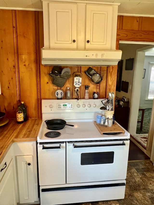 kitchen featuring electric range and white cabinetry