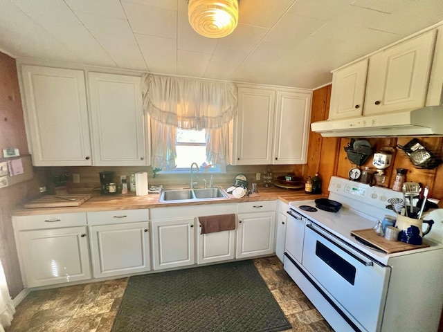 kitchen with electric stove, white cabinetry, and sink