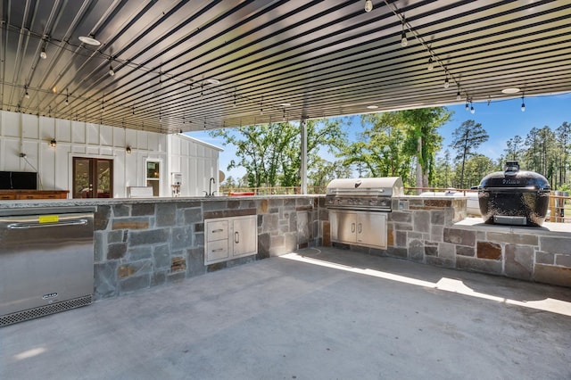 view of patio featuring area for grilling and sink