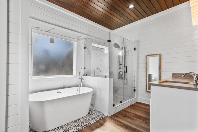 bathroom featuring wood ceiling, a wealth of natural light, independent shower and bath, and hardwood / wood-style flooring