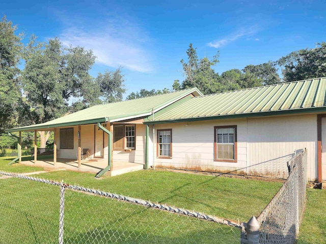 view of front of property with a front yard and a patio