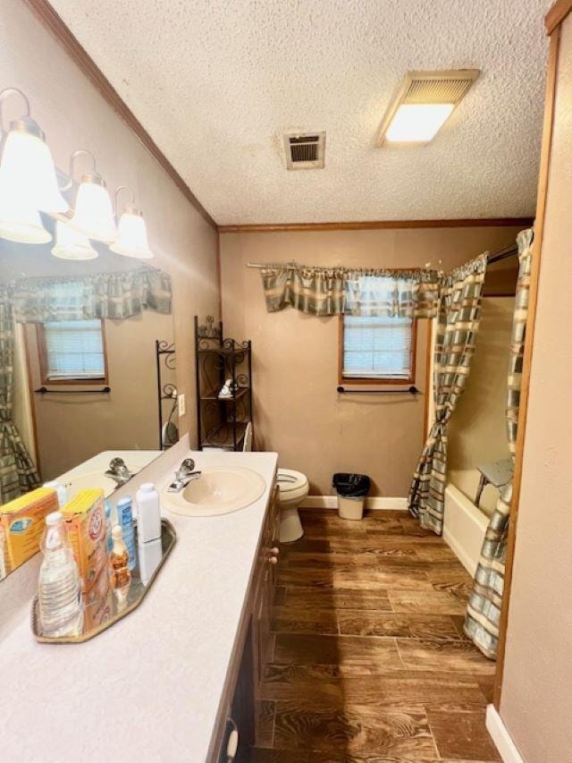 full bathroom with vanity, hardwood / wood-style flooring, toilet, shower / bathtub combination with curtain, and ornamental molding