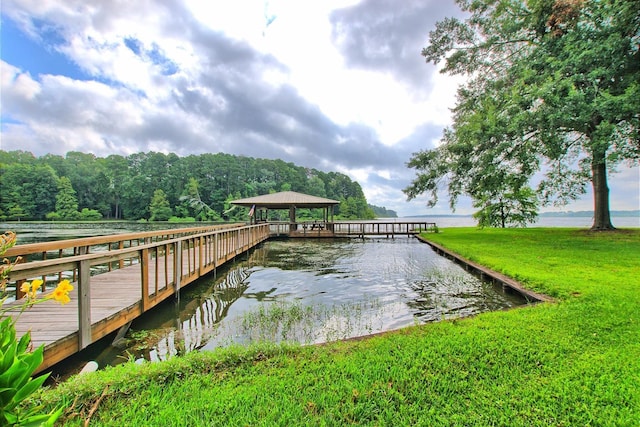 dock area featuring a yard and a water view