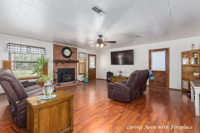 living room with dark wood-style floors, visible vents, and a healthy amount of sunlight