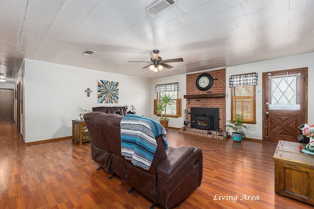 living area featuring visible vents, dark wood-type flooring, and a wealth of natural light