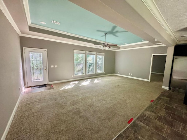 2505 County Road 4420, Spurger, TX 77660 - unfurnished living room featuring a tray ceiling, ornamental molding, baseboards, and a ceiling fan