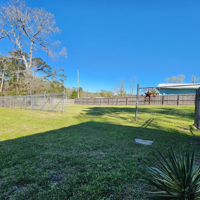 view of yard with a fenced backyard
