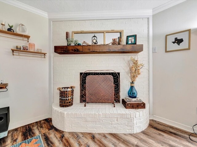 details featuring hardwood / wood-style floors, crown molding, and a brick fireplace