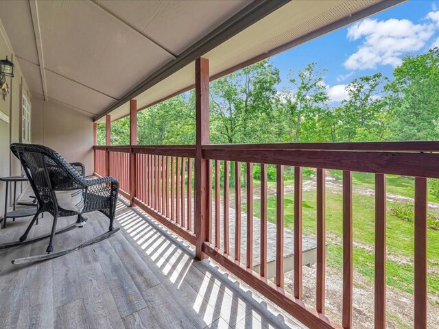 wooden deck featuring a lawn