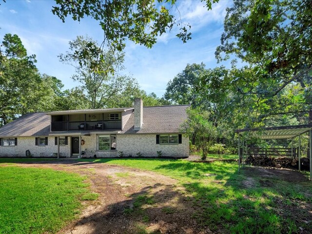 back of property featuring a lawn and a pergola