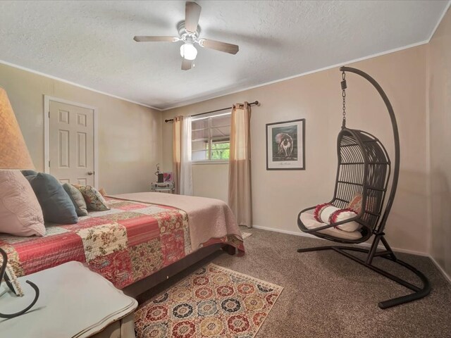 carpeted bedroom featuring ceiling fan, crown molding, and a textured ceiling