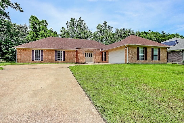 ranch-style house featuring concrete driveway, brick siding, an attached garage, and a front lawn