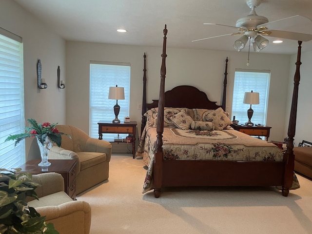 carpeted bedroom with multiple windows and ceiling fan