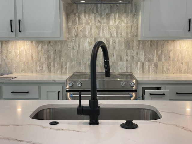 room details featuring light stone countertops and tasteful backsplash