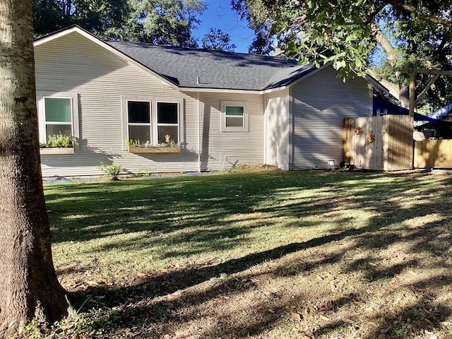 rear view of property with a lawn