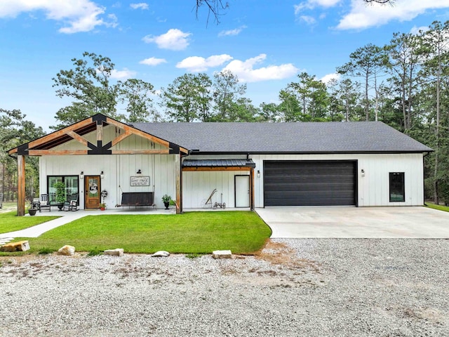 modern inspired farmhouse featuring a front yard and a garage