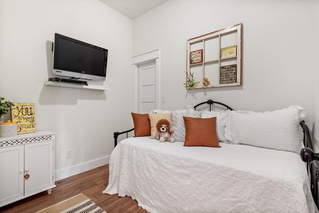 bedroom with dark hardwood / wood-style flooring