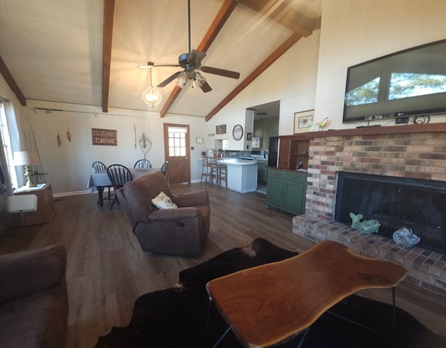 living room featuring high vaulted ceiling, beamed ceiling, hardwood / wood-style flooring, ceiling fan, and a brick fireplace