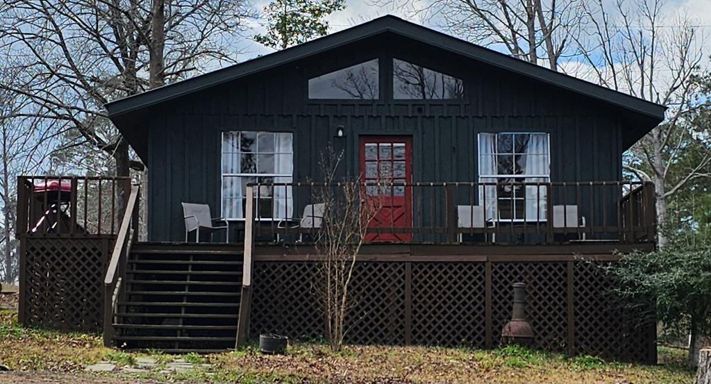 back of house featuring a wooden deck