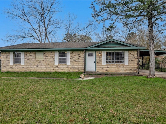 ranch-style house featuring a front yard and a carport