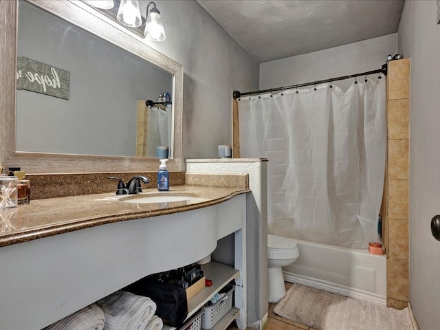 full bathroom with shower / bath combo, vanity, tile patterned flooring, toilet, and a textured ceiling