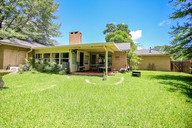 206 Spyglass Dr, Lufkin, TX 75901 - rear view of property with a chimney, brick siding, and a patio