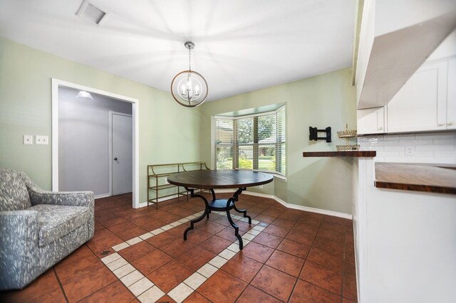 206 Spyglass Dr, Lufkin, TX 75901 - dining room featuring dark tile patterned flooring and a chandelier