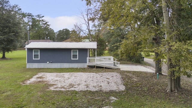 view of property exterior with a lawn and a deck