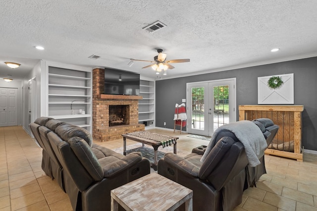 920 Richardson Dr, Jasper, TX 75951 - living area featuring a ceiling fan, built in shelves, baseboards, french doors, and a textured ceiling