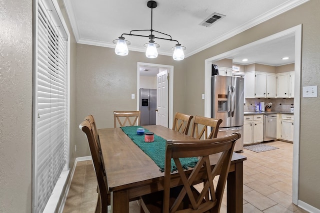 920 Richardson Dr, Jasper, TX 75951 - dining room featuring a textured wall, ornamental molding, and light tile patterned floors