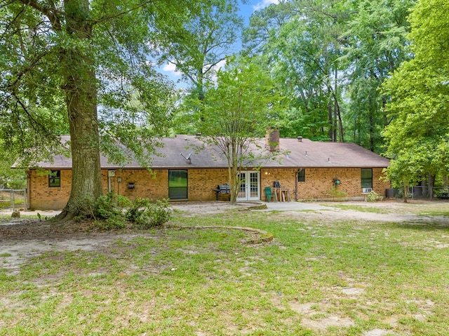 920 Richardson Dr, Jasper, TX 75951 - rear view of property featuring french doors, a chimney, a patio, and brick siding