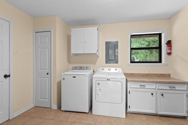 920 Richardson Dr, Jasper, TX 75951 - washroom featuring cabinet space, electric panel, washer and clothes dryer, light tile patterned floors, and baseboards