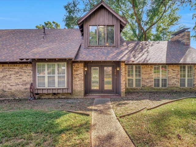 view of front of house featuring a front lawn and french doors