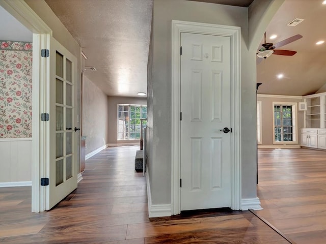 corridor featuring dark wood-type flooring and a textured ceiling