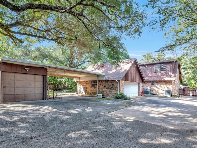 view of front of house featuring a carport, central AC unit, and a garage