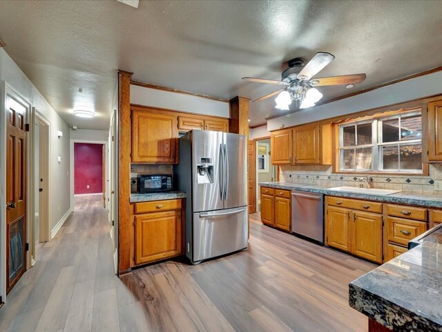 kitchen featuring tasteful backsplash, sink, hardwood / wood-style floors, and stainless steel appliances